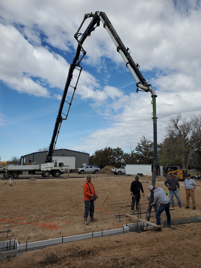 Workers pouring concrete footings