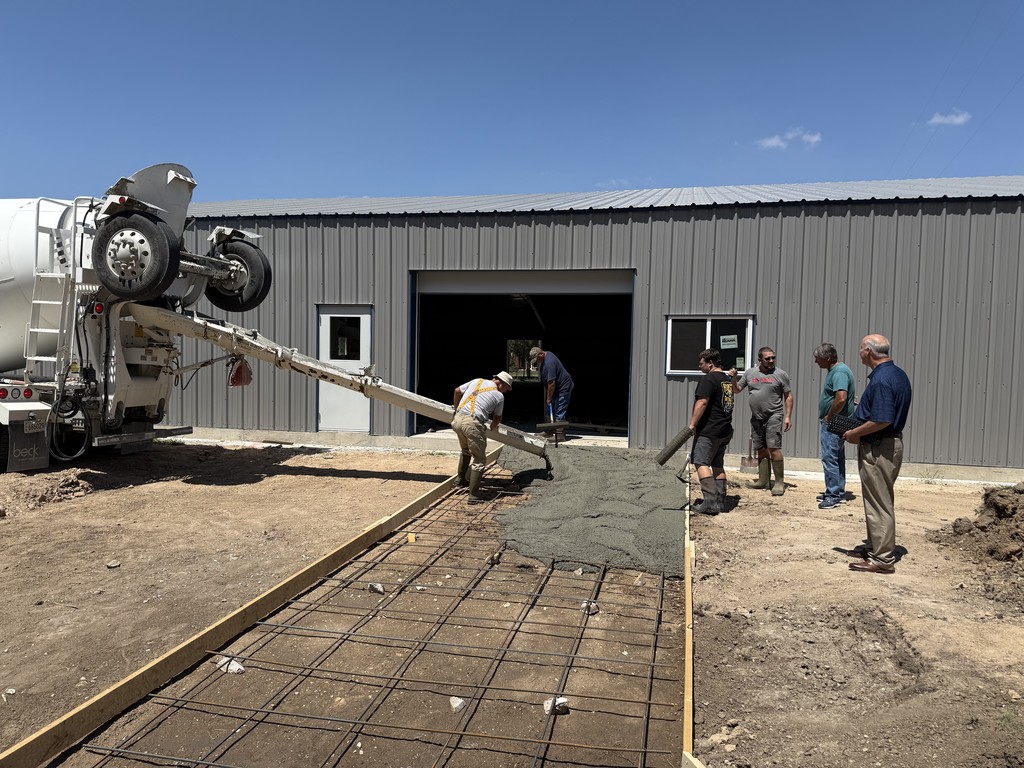 Volunteers pour part of the concrete driveway to the CLB