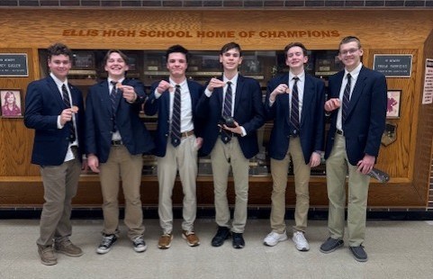 TMP-M students pose with their scholar's bowl medals in front of the Ellis High trophy case.