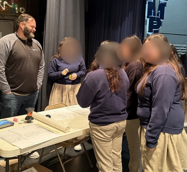 Students learn more about surveying at a table