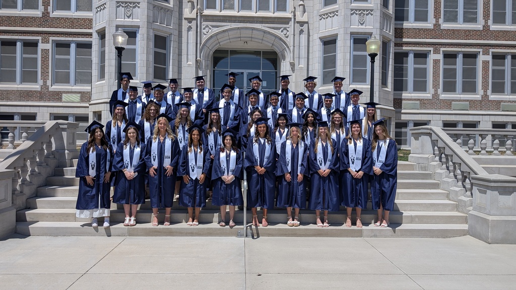 TMP-Marian Graduates in blue gowns and white stoles