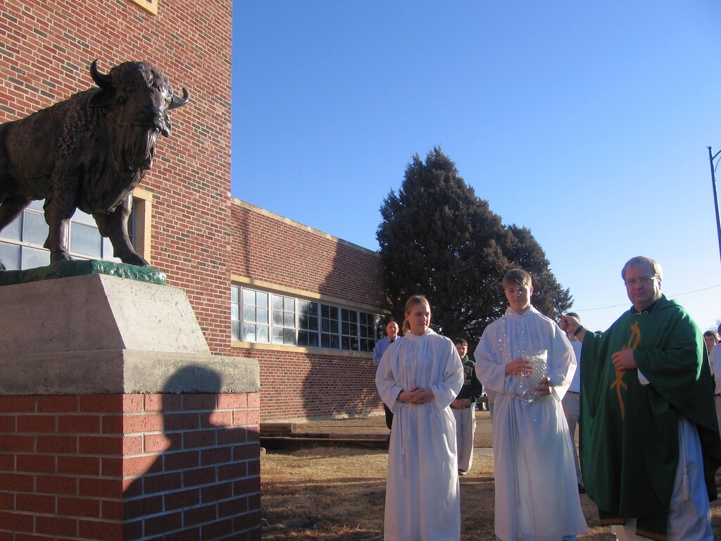 Fr. Fred blesses the bison statue in 2007.