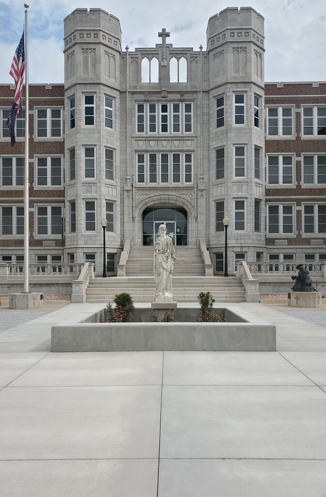 Front entrance of Thomas More Prep-Marian with statue in front