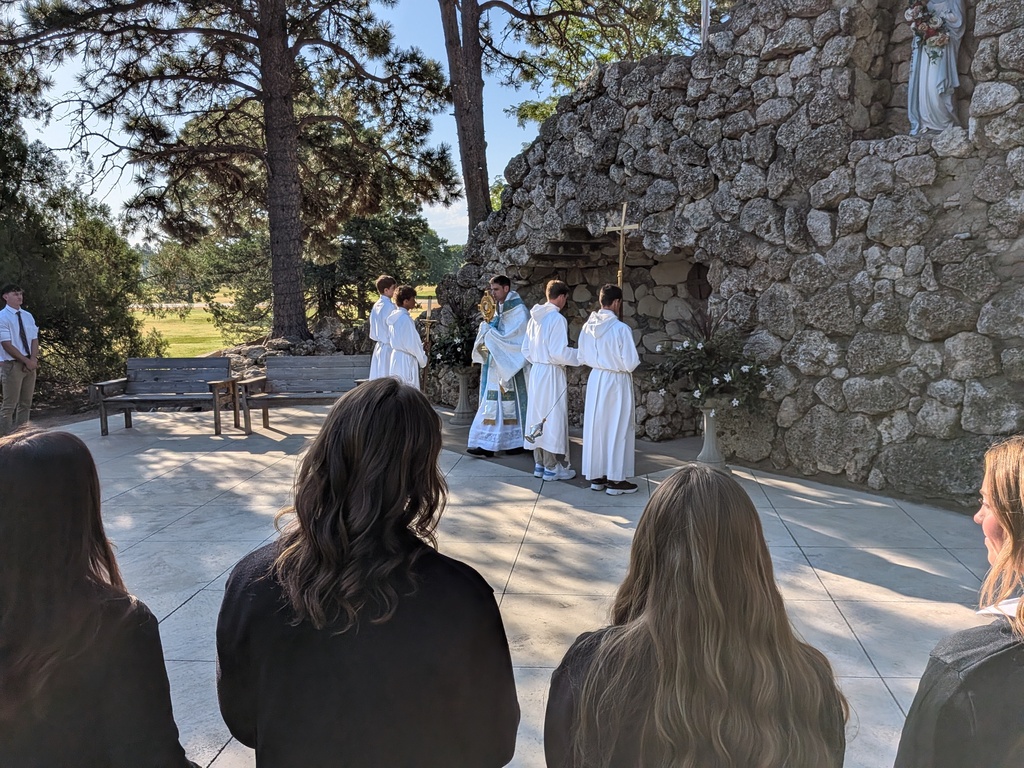 Students praying in the grotto