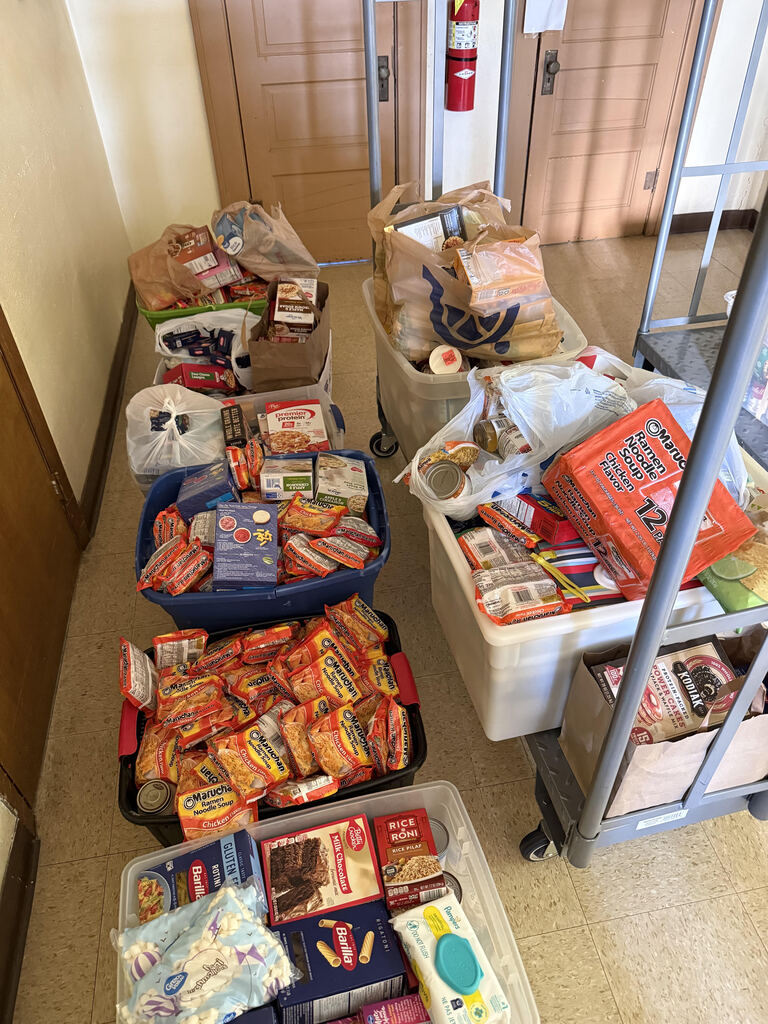 Food stuffs in boxes sitting on the floor