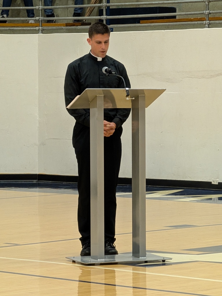 Fr. Luke gives a fervorino to the students, staff, and guests while on the gym floor.