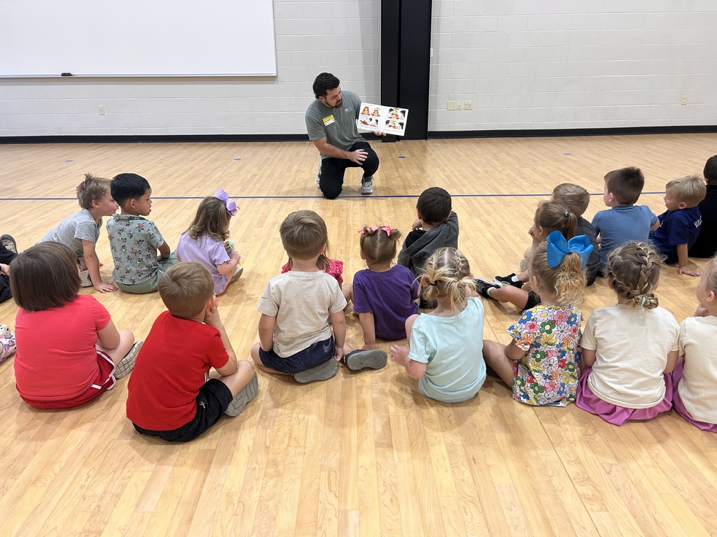 Dr. Sparks reads a book to the students