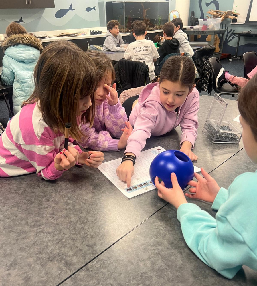 students work out enrichment for zoo animals