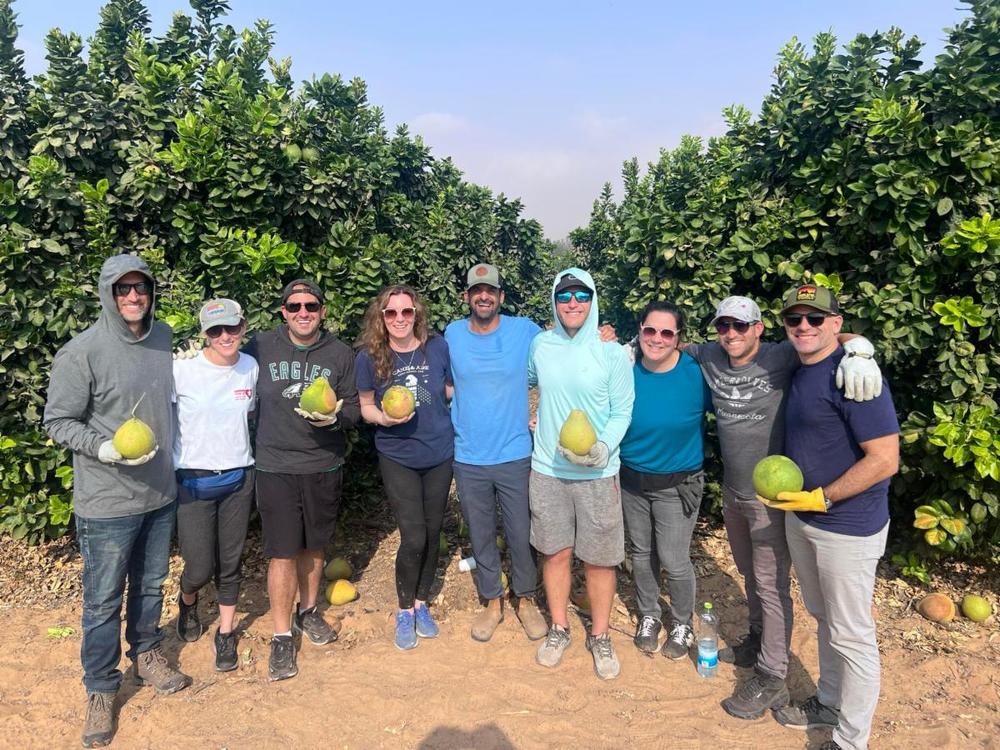 SJA parents volunteer in the orchards of Kibbutz Holit