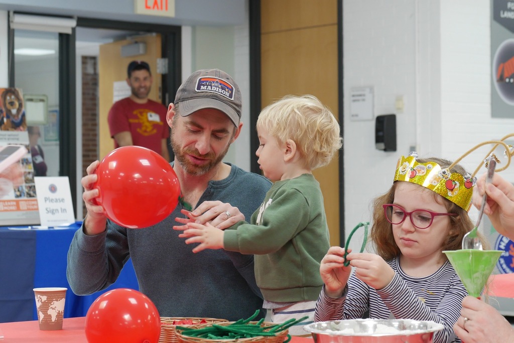 Father and student working on a craft together