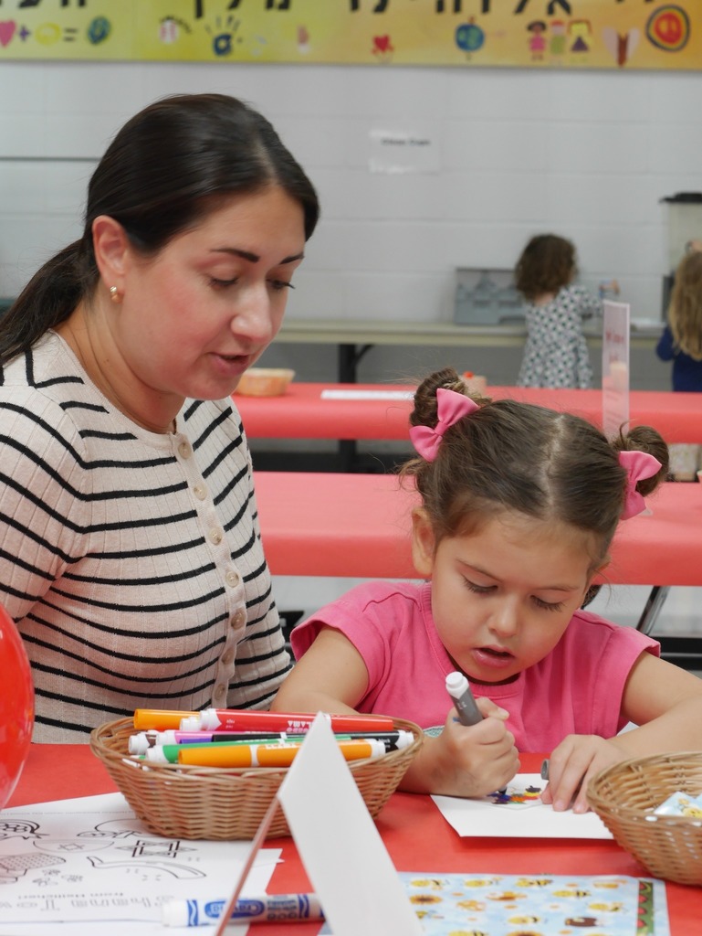Mother and student working on a craft together