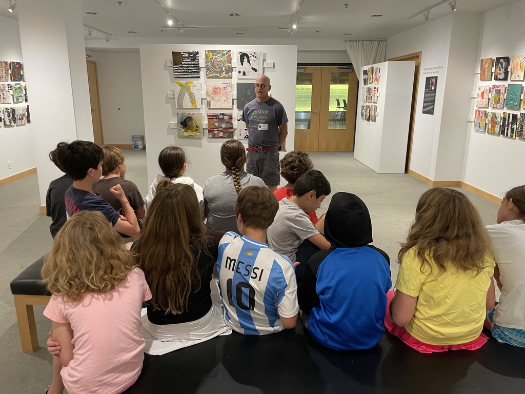 Owen speaks to students in art gallery