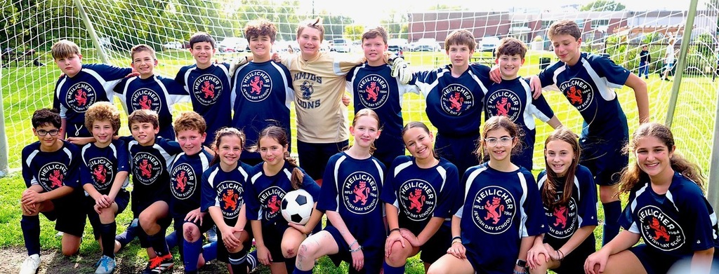 Heilicher soccer team poses for a photo in front of soccer net