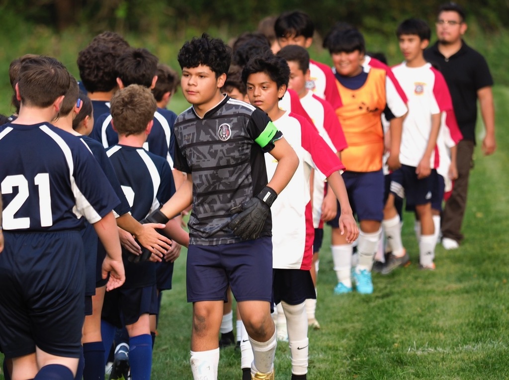 Partnership Academy players and Heilicher players line up to congratulate each other on a good game