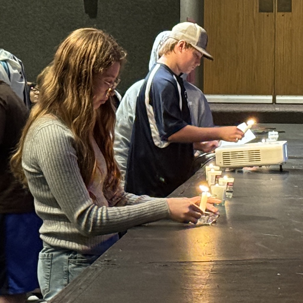 Students light yahrzeit candles