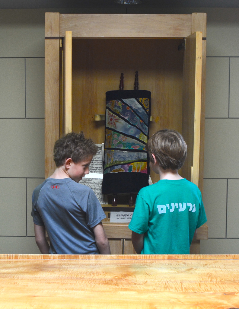 two boys discuss question at Torah in ark