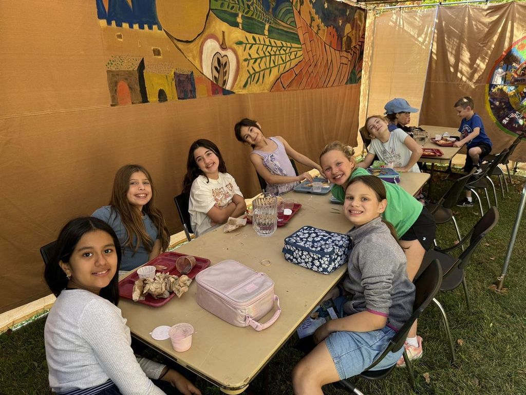 students eat lunch in the sukkah
