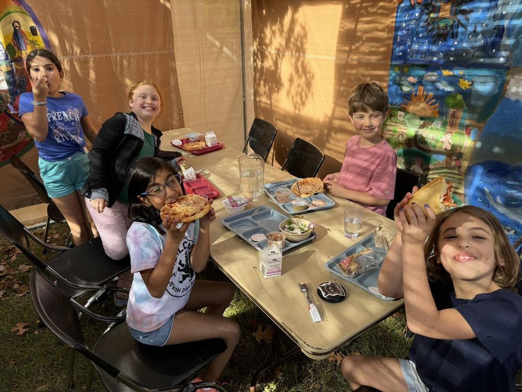students eat lunch in the sukkah