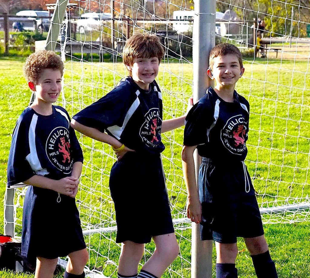 heilicher players smile by soccer goal