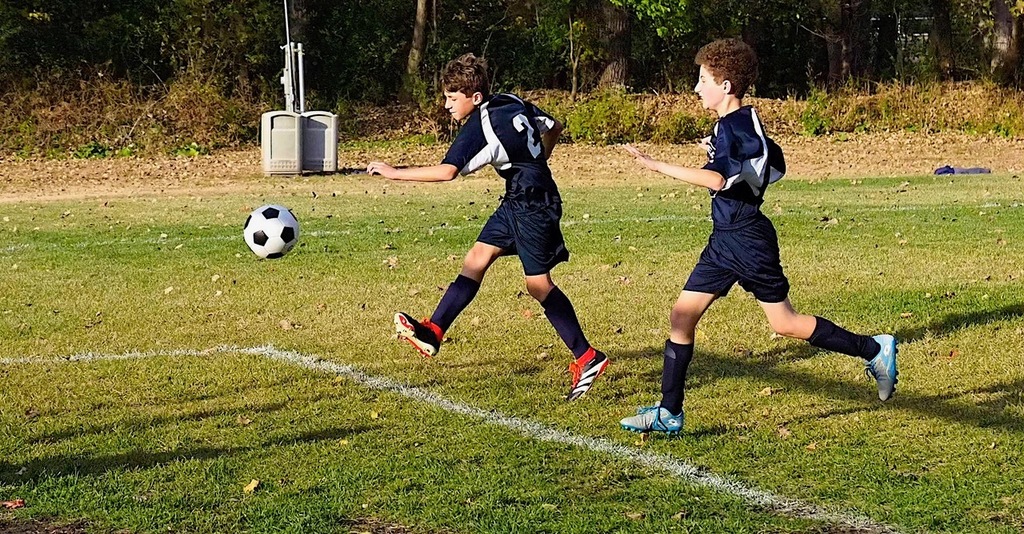 heilicher player kicks soccer ball