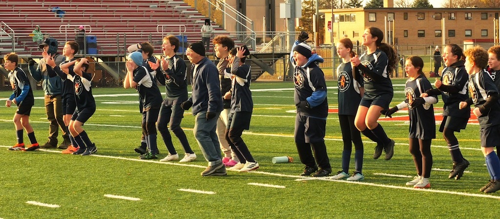 heilicher team jumps up and down and screams from sideline