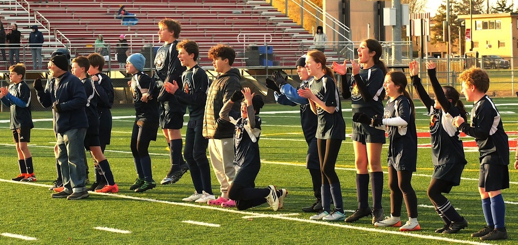 heilicher team jumps up and down and screams from sideline