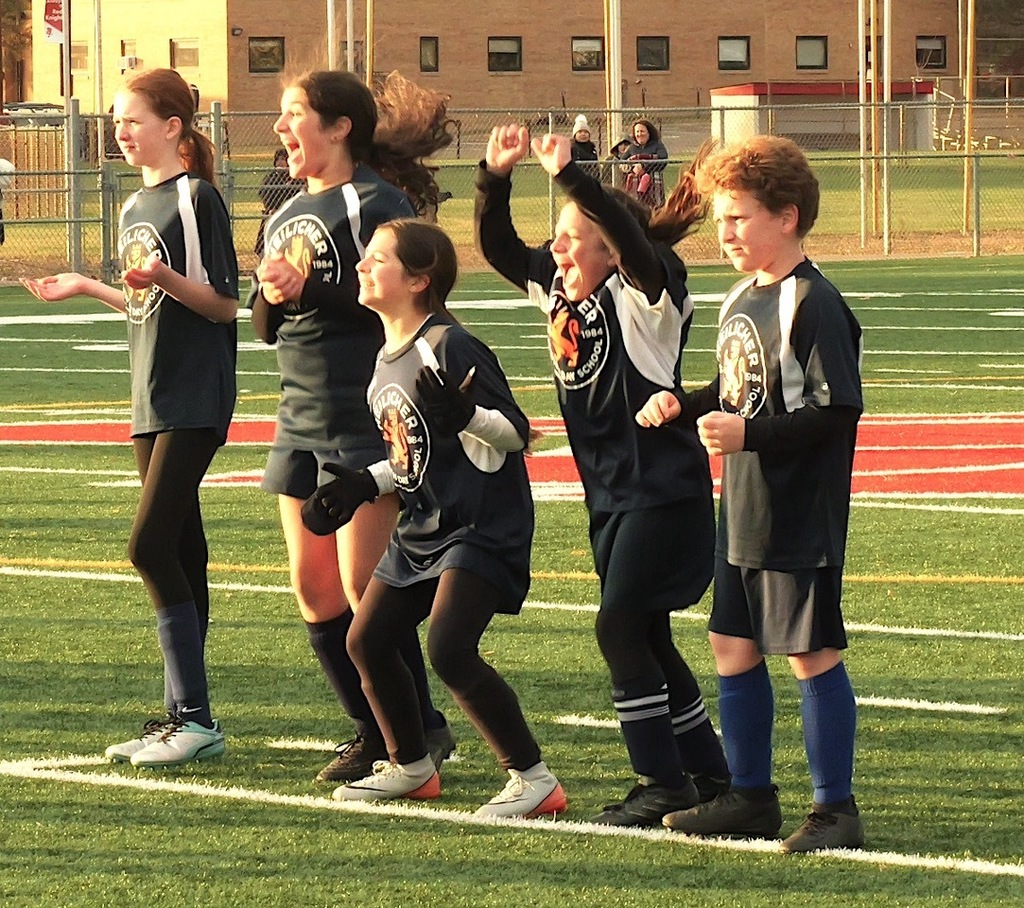 heilicher team jumps up and down and screams from sideline