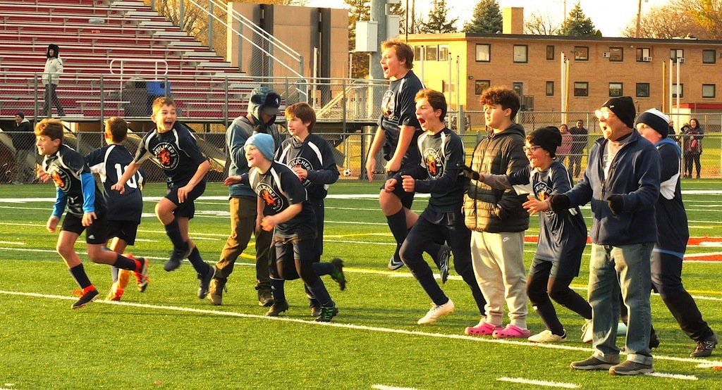 heilicher team jumps up and down and screams from sideline