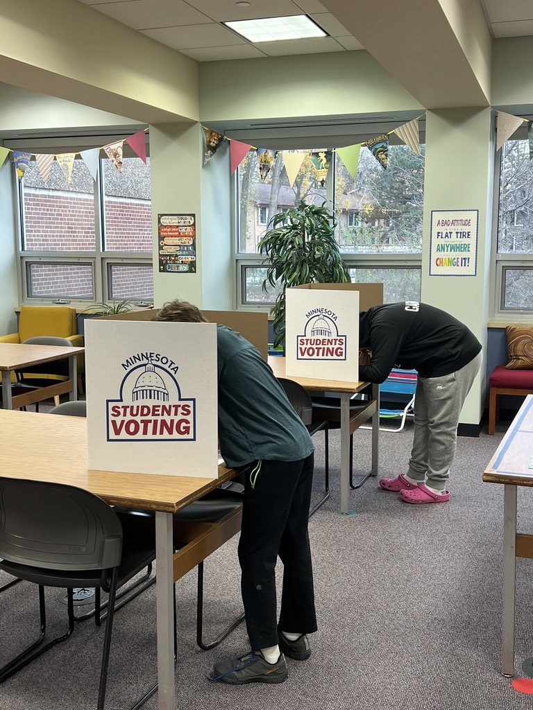 eighth graders vote in minnesota students voting booths