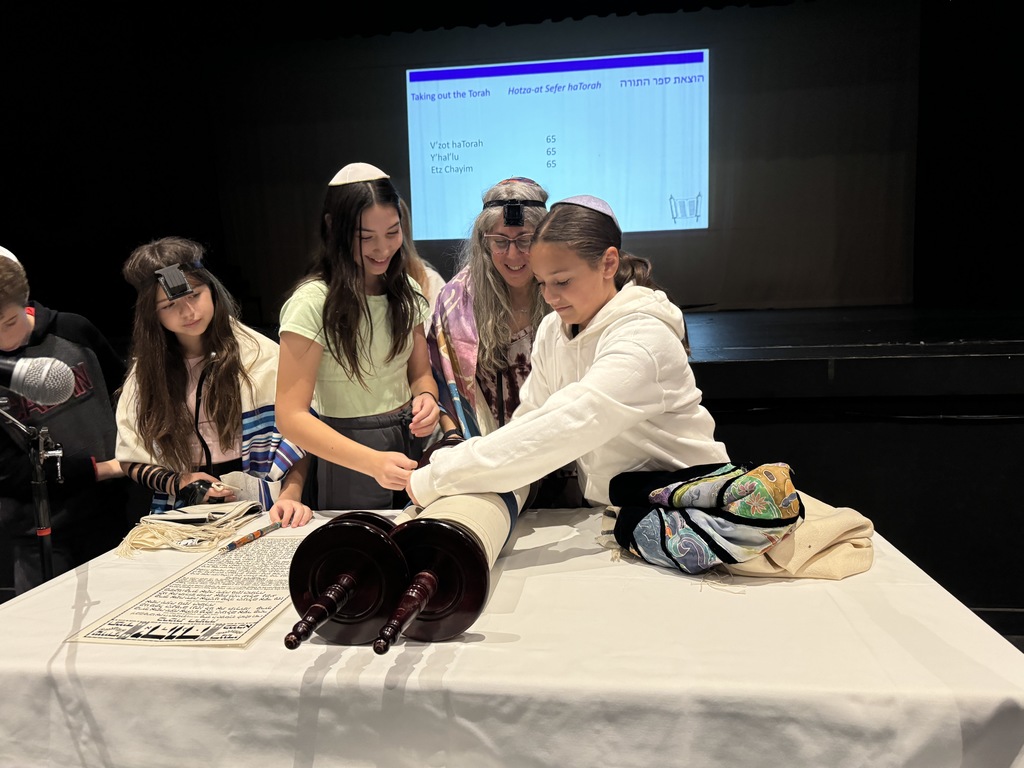 two seventh-grade girls dress Torah