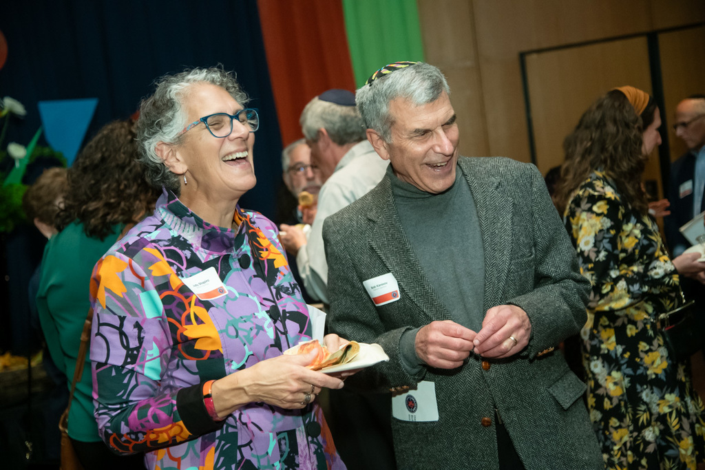 two people laugh in conversation