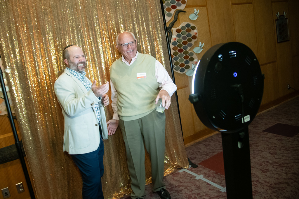 two men smile for photobooth picture