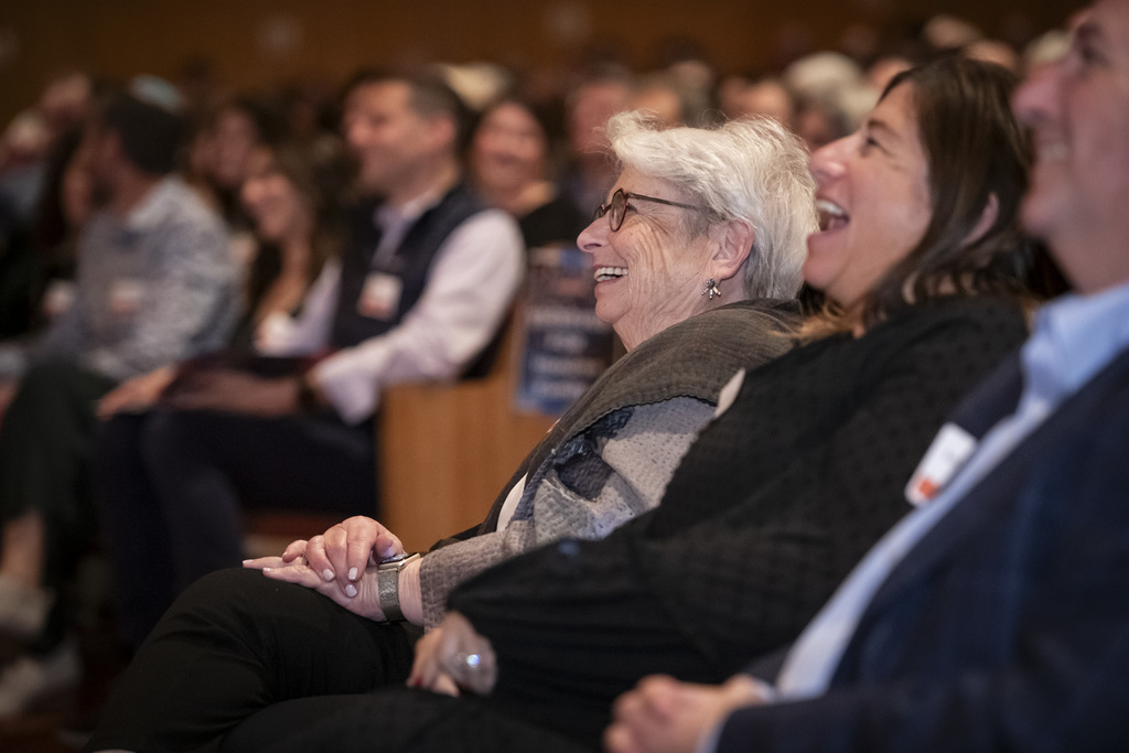 honoree and other attendees laugh in audience