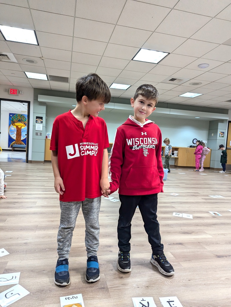 two boys in matching red hold hands