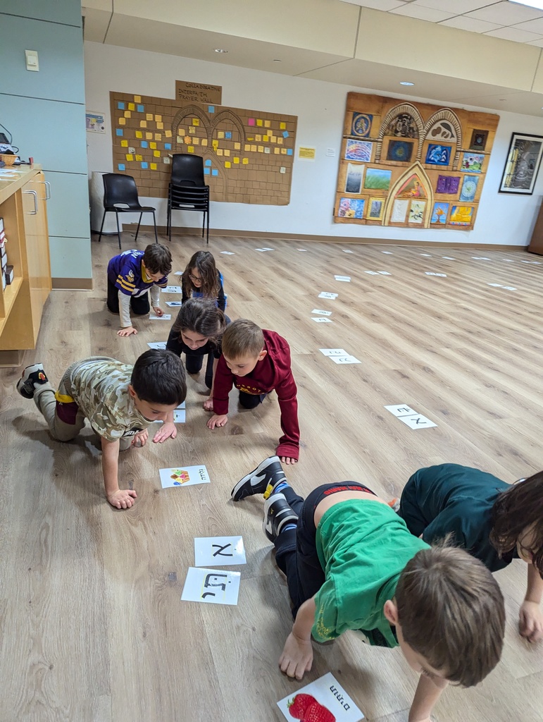 first graders crawl along maze of hebrew letters