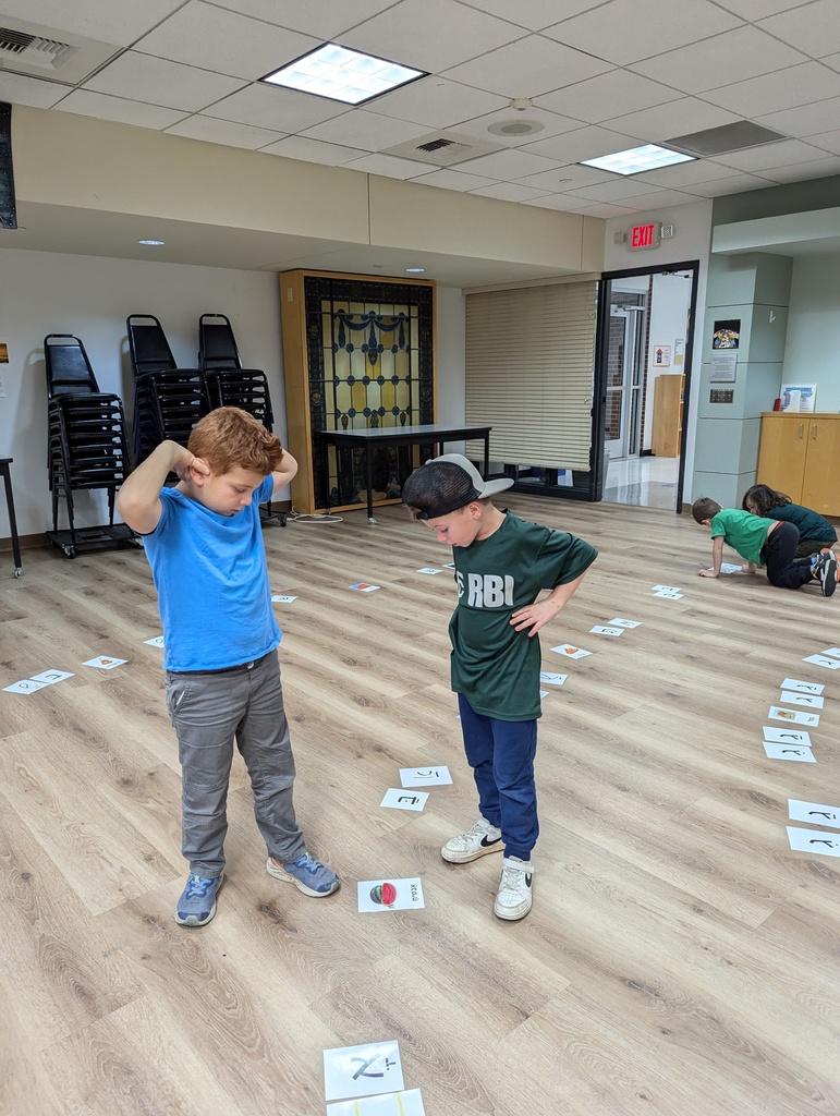 two students look at hebrew laid out on floor