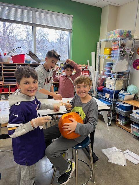 students take seeds out of pumpkin