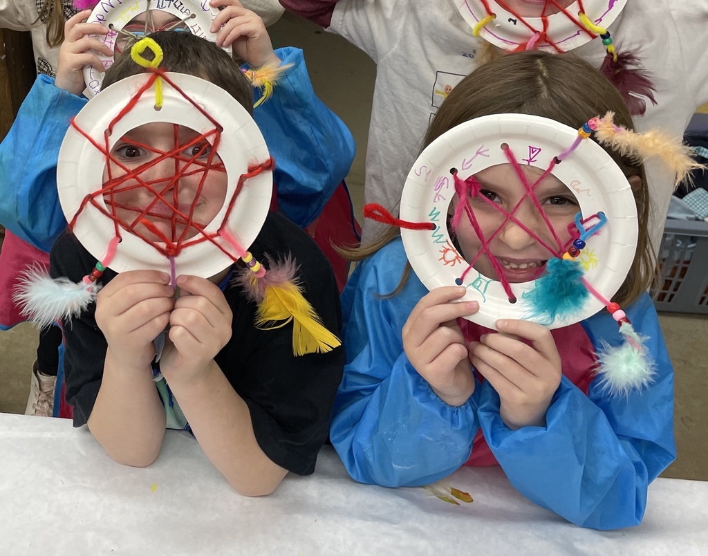 Students hold dream catchers made in art class