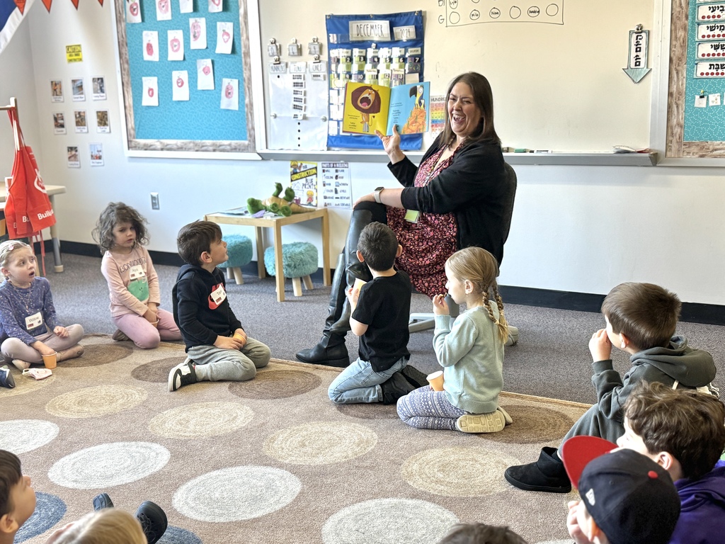 kindergarten teacher reads to pre-k students