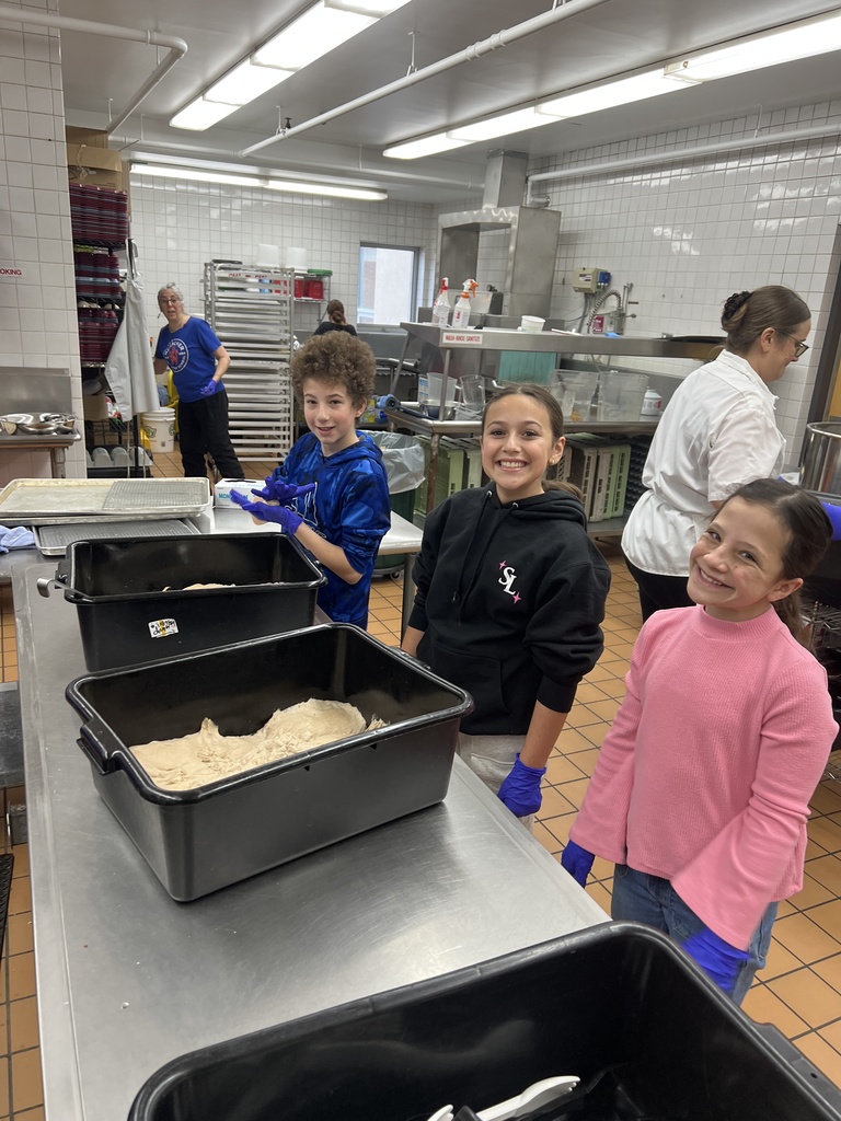 students smile in kitchen