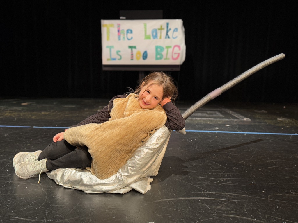 student performs as the big latke
