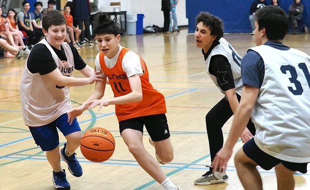 student dribbles ball through defense
