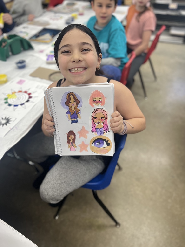 student shows sketchbook