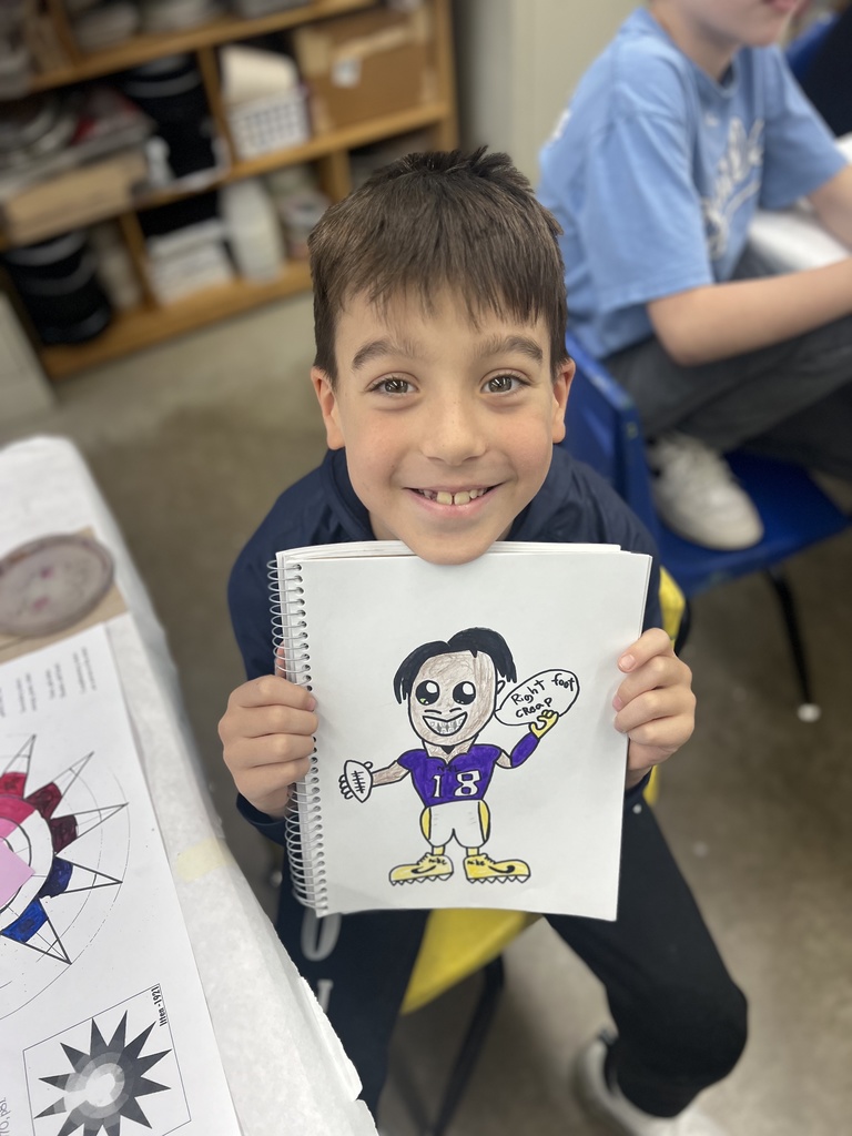 student shows sketchbook