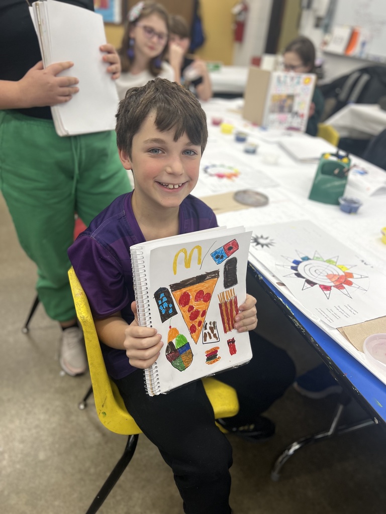 student shows sketchbook