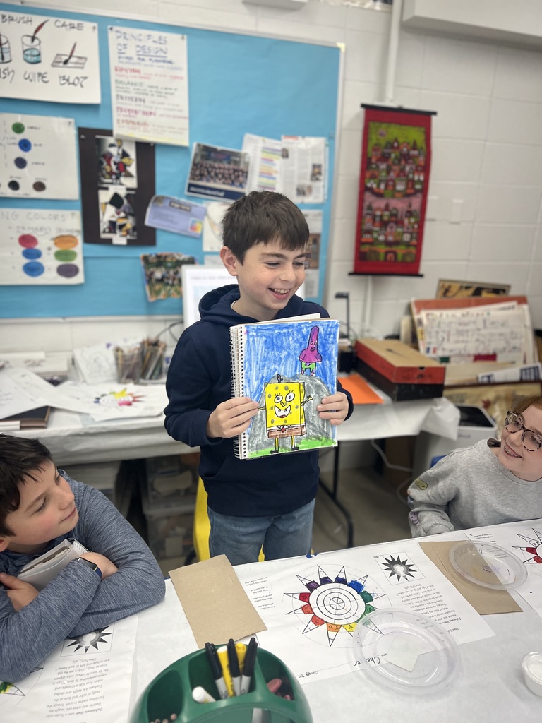 student shows sketchbook