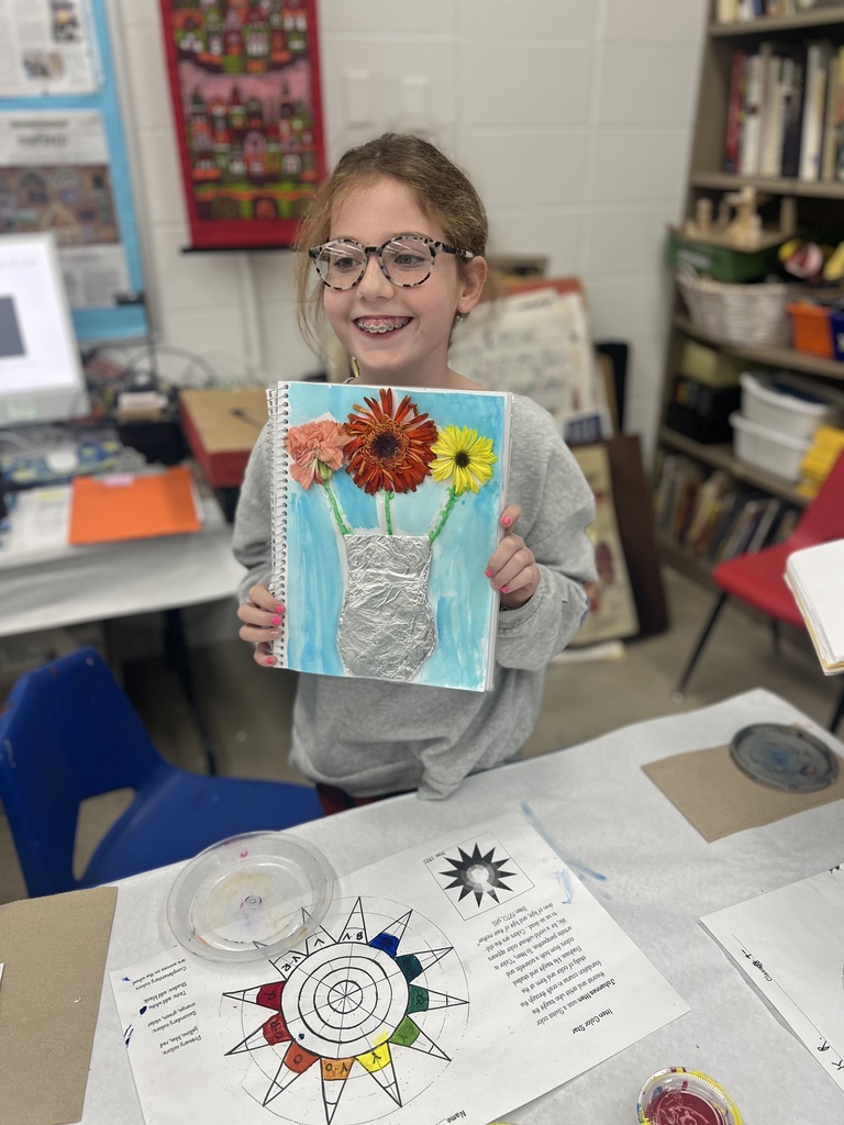 student shows sketchbook