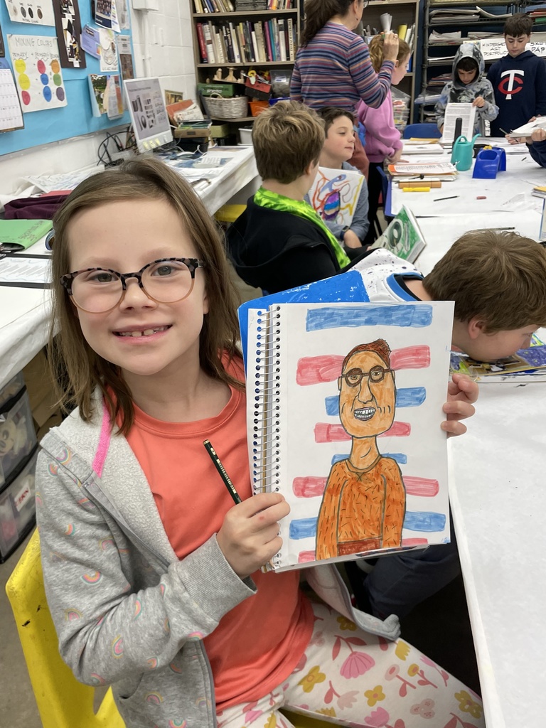 student shows sketchbook