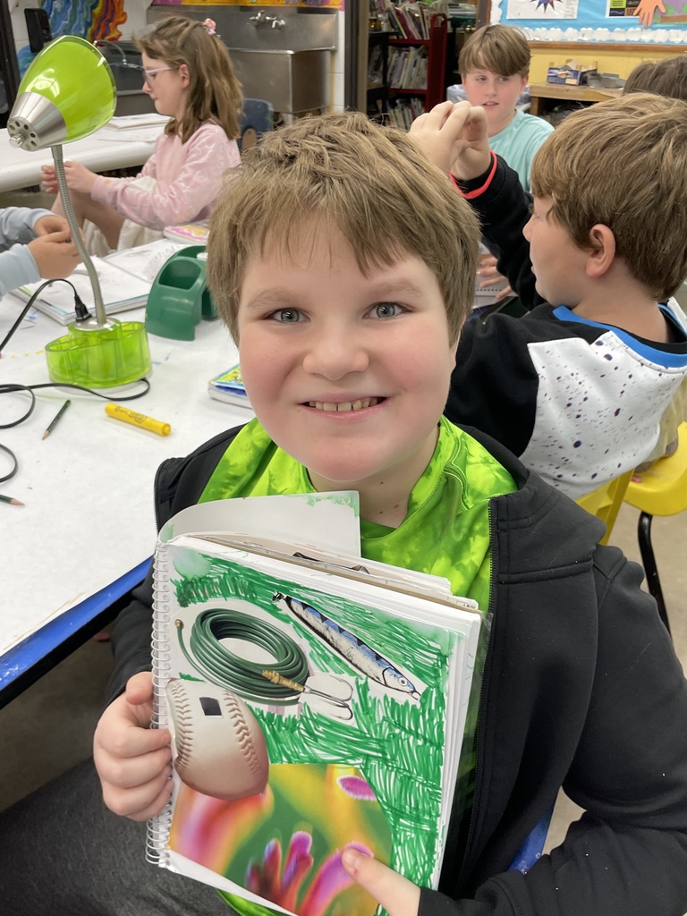 student shows sketchbook