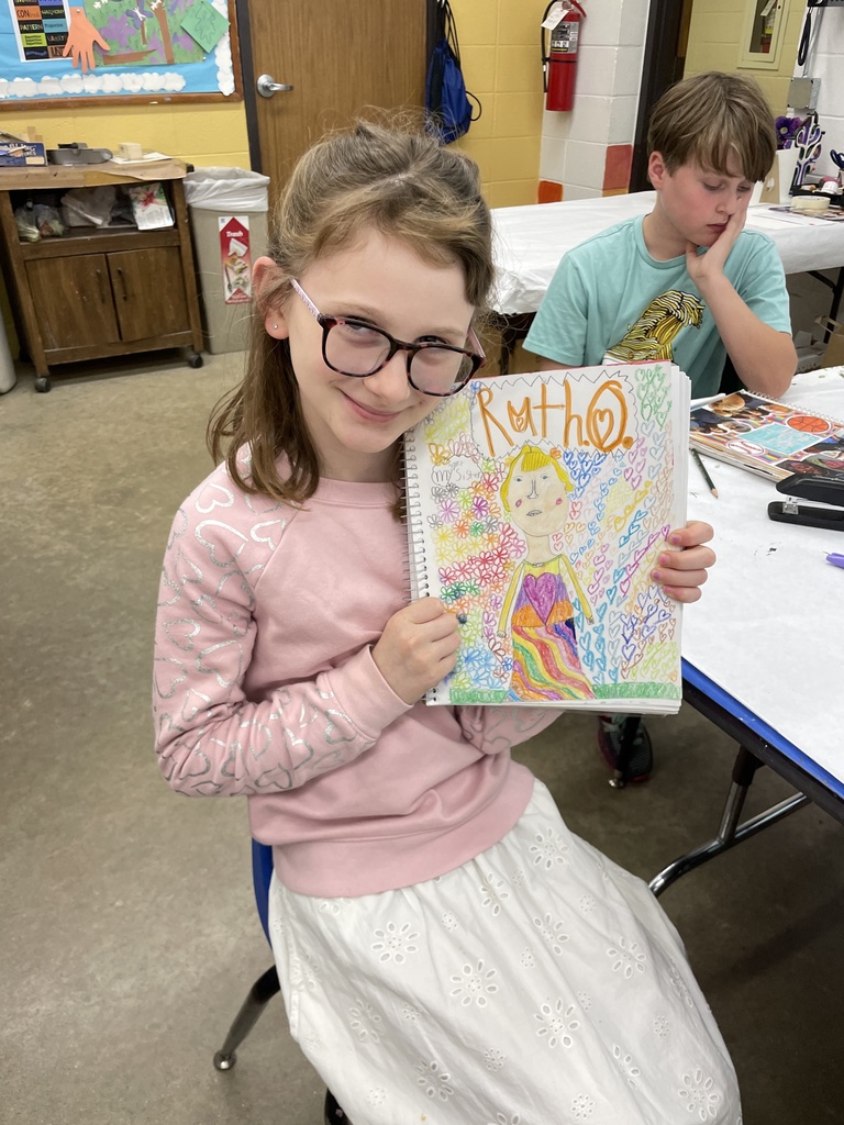 student shows sketchbook